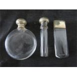 Three small silver topped perfume bottles