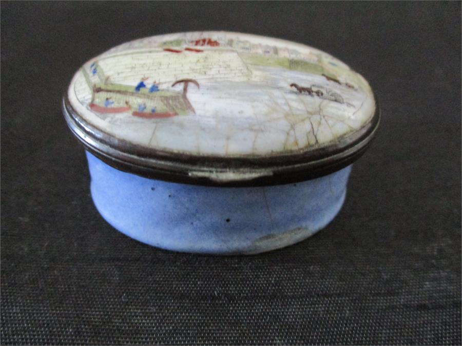 A 19th century hand painted enamelled patch pot decorated with a harbour scene, mirror to lid A/F