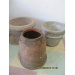 Two concrete garden pots and a small terracotta rhubarb forcer