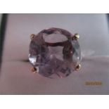 A 9ct gold ring set with a pale amethyst approx 6.5 ct ( slight chips and slight feathering to