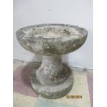 A small concrete bird bath