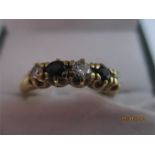 A diamond and sapphire five stone ring set in gold ( probably 18ct- hallmarked rubbed)