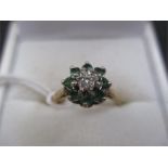 A diamond and emerald cluster ring set in 18ct gold