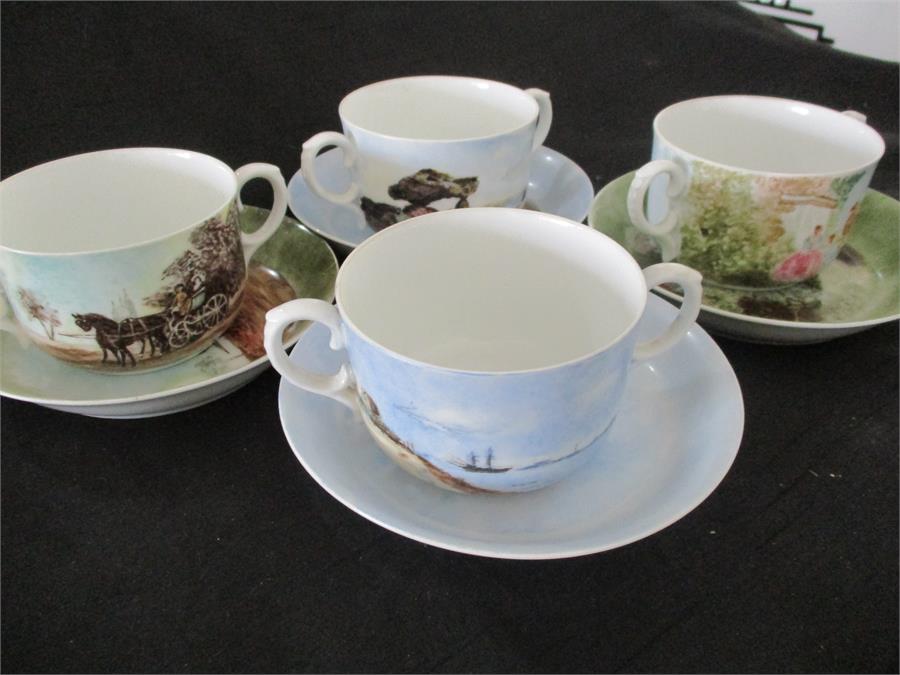 A set of four two handled cups and saucers by Royal Copenhagen, decorated with paintings by famous