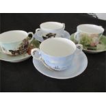 A set of four two handled cups and saucers by Royal Copenhagen, decorated with paintings by famous