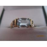 An aquamarine and diamond ring set in 9ct gold