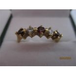 A diamond and ruby five stone ring set in 18ct gold