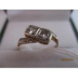 A diamond crossover ring set in unmarked gold