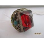 A Chinese SCM ring set with a cabochon stone and enamel detailing to shoulders, four character