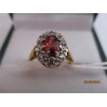 A diamond and garnet cluster ring set in 18ct gold
