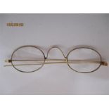 A pair of gold coloured vintage spectacles