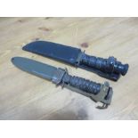 An American M1 knife bayonet and scabbard by B M Co, marked USM8A1 and an American WWII Navy knife