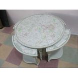 A round painted nest of five tables with maps under glass tops