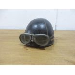 A pre war motorcycle helmet and goggles