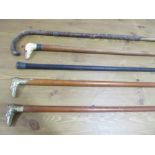 Five various walking sticks including 2 silver mounted and a dogs head with beaded eyes