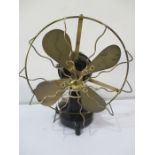 A 1930's brass bladed fan with iron base by EMI, type M.E 2