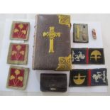 A brass bound common prayer book, leather purse and military badges