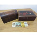 An inlaid dome topped tea caddy with a lacquered box and a small quantity of cigarette cards