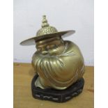 An Oriental brass sleeping Buddhistic figure on stand height 17cm incl. stand