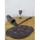 A metal actors mask on stand, wooden oyster plate, riding crops and a wine bottle carrier