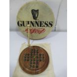 A Guinness advertising Bodhran by Waltons along with a solitaire board with marbles