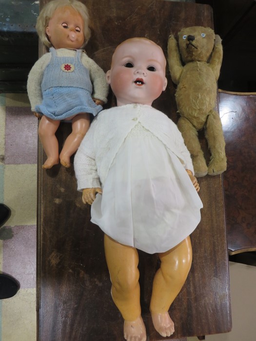A large Armand Marseille bisque headed doll with open mouth and two teeth( eyes loose inside