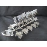 A silver plated toast rack formed of vine leaves