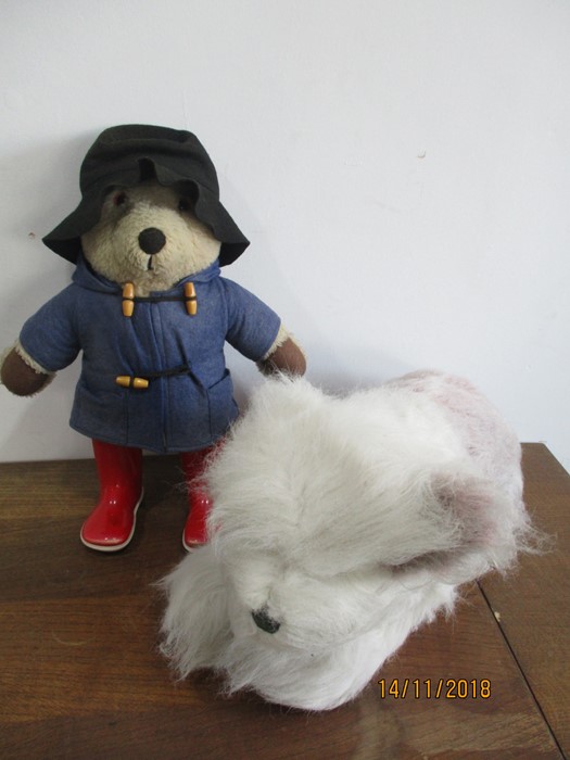 Paddington Bear along with a dog soft toy