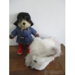 Paddington Bear along with a dog soft toy