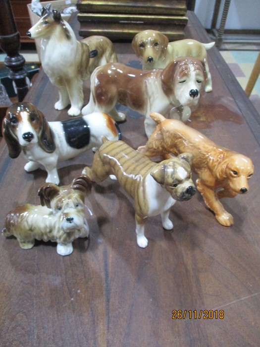 A collection of seven dog ornaments including Coopercraft