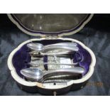 An antique cased set of 16 continental silver spoons and matching sugar tongs, the case with ivory