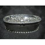 A hallmarked silver oval ring box