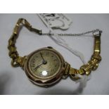 A 9 ct rose gold ladies wristwatch on gold plated strap