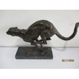 A bronze figure of a running panther on plinth, overall 41cm length