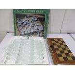 A boxed glass chess set along with one other