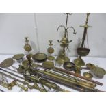 A quantity of various brass ware to include stirrup pumps, wall hangings, fire irons etc