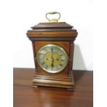 An inlaid bracket clock with brass mountings