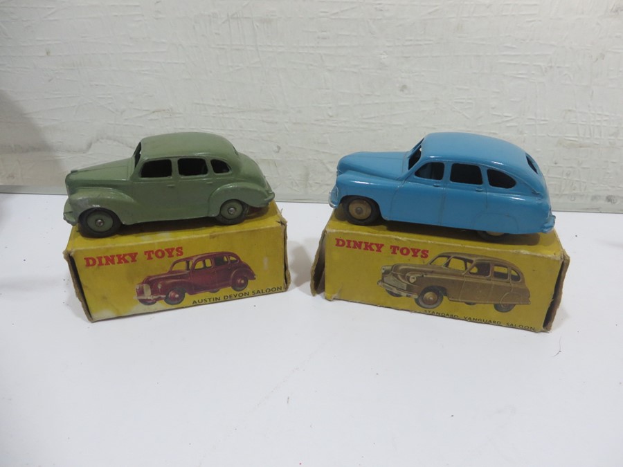 Two boxed Dinky Toys diecast car models, an Austin Devon Saloon (152) 40D and a Standard Vanguard