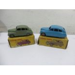 Two boxed Dinky Toys diecast car models, an Austin Devon Saloon (152) 40D and a Standard Vanguard