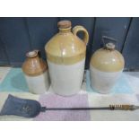 Three stoneware jugs along with a brass and iron fireside shovel