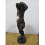 A bronze figure of a scantily draped slave girl with her hands bound above her head, good