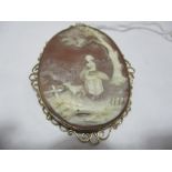 A 9 ct gold mounted cameo with a girl collecting wheat with her dog under a tree, cameo measures 5.