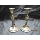 A pair of hallmarked silver candlesticks- 1 A/F