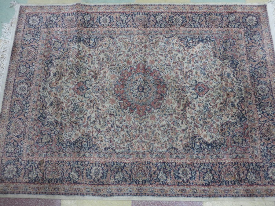 A cream ground rug 140cm x 100cm