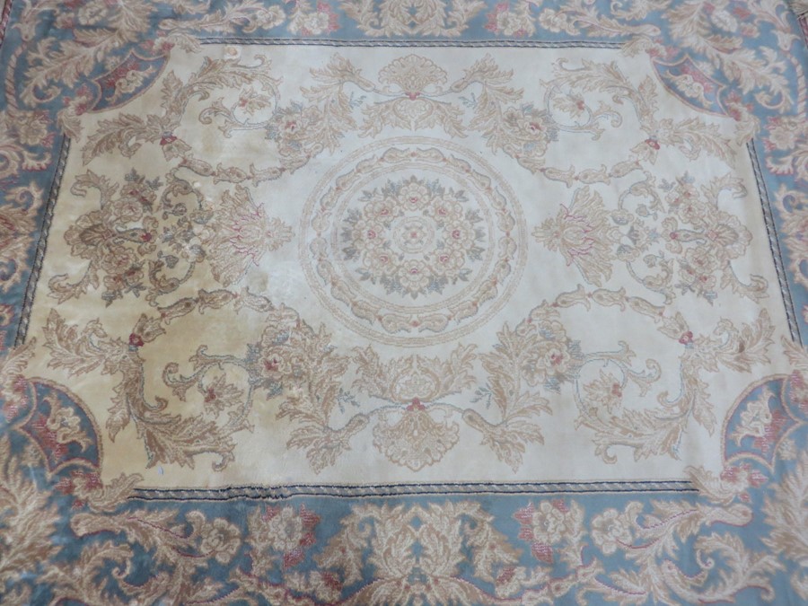 A cream ground rug 165cm x 125cm