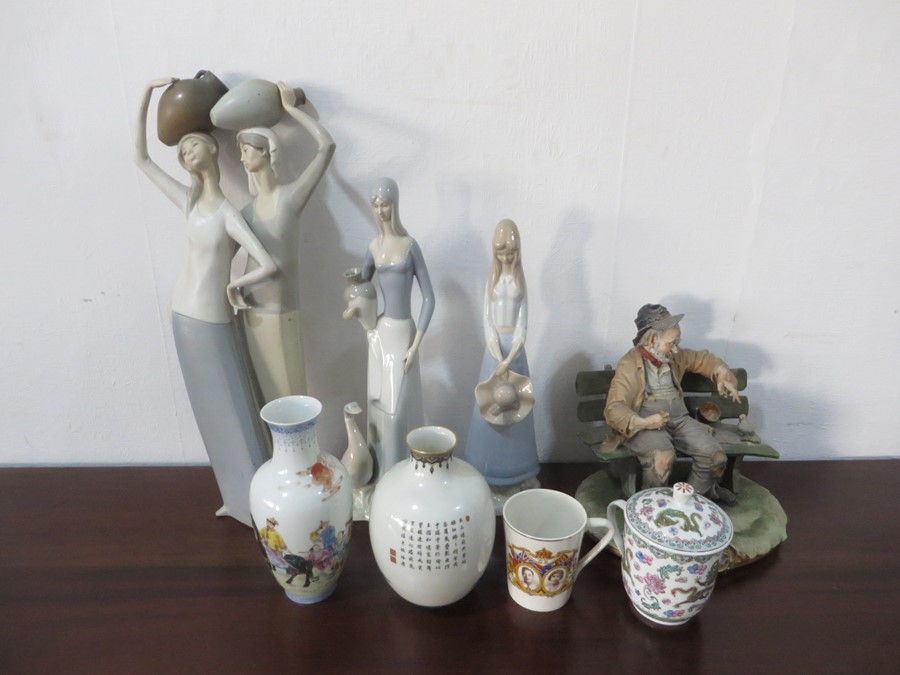 A large Lladro figure of two women holding pots on their head A/F, two other Lladro style figures,