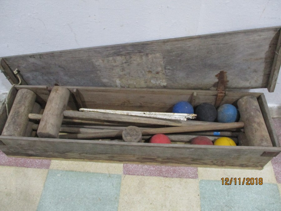 A vintage croquet set in wooden box