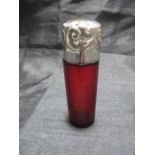 A silver topped cranberry scent bottle