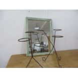 Two wrought iron plant pot stands and an antique mirror