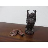 Two wooden carved figures of a fish and a Buddhist man